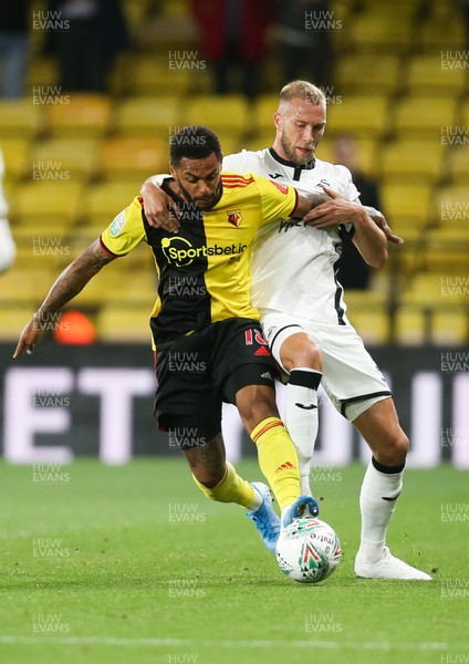 240919 - Watford v Swansea City, Carabao Cup, Third Round - Andre Gray of Watford and Mike van der Hoorn of Swansea City compete for the ball