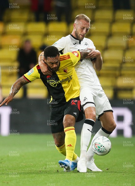 240919 - Watford v Swansea City, Carabao Cup, Third Round - Andre Gray of Watford and Mike van der Hoorn of Swansea City compete for the ball