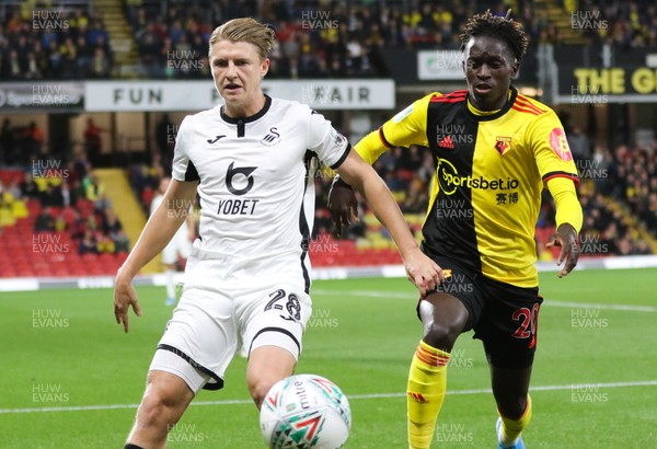 240919 - Watford v Swansea City, Carabao Cup, Third Round - George Byers of Swansea City holds off the challenge from Domingos Quina of Watford