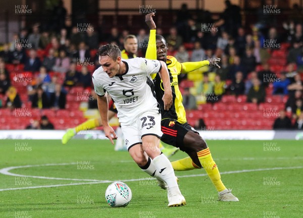 240919 - Watford v Swansea City, Carabao Cup, Third Round - Connor Roberts of Swansea City holds off Abdoulaye Doucoure of Watford