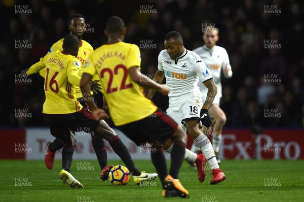 301217 - Watford v Swansea City - Premier League - Jordan Ayew of Swansea City is challenged by Abdoulaye Doucoure of Watford