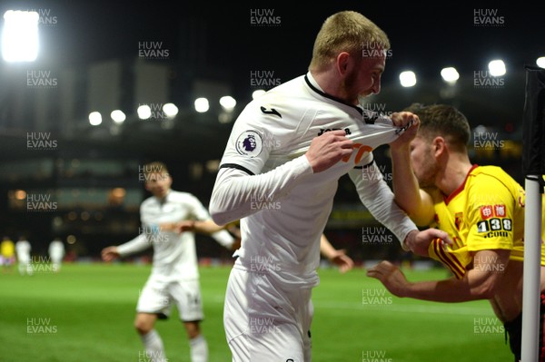 301217 - Watford v Swansea City - Premier League - Oliver McBurnie of Swansea City tangles with Tom Cleverley of Watford