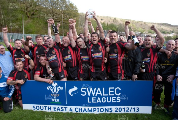 110513 - Wattstown v Pontycymmer, SWALEC League 4 South East - Wattstown RFC captain Nathan Bruford is presented with the SWALEC League 4 South East trophy by WRU board member Humphrey Evans, with coaches Dano Roberts, left, Wayne Davies and Christopher Davies, right