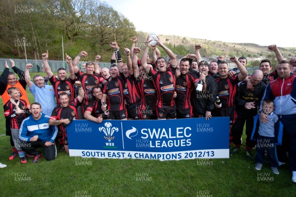 110513 - Wattstown v Pontycymmer, SWALEC League 4 South East - Wattstown RFC captain Nathan Bruford is presented with the SWALEC League 4 South East trophy by WRU board member Humphrey Evans, with coaches Dano Roberts, left, Wayne Davies and Christopher Davies, right