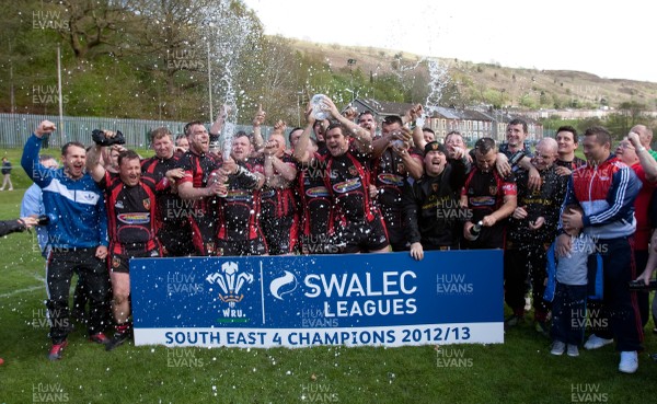 110513 - Wattstown v Pontycymmer, SWALEC League 4 South East - Wattstown RFC captain Nathan Bruford is presented with the SWALEC League 4 South East trophy by WRU board member Humphrey Evans, with coaches Dano Roberts, left, Wayne Davies and Christopher Davies, right