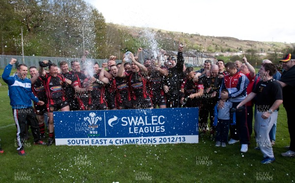 110513 - Wattstown v Pontycymmer, SWALEC League 4 South East - Wattstown RFC captain Nathan Bruford is presented with the SWALEC League 4 South East trophy by WRU board member Humphrey Evans, with coaches Dano Roberts, left, Wayne Davies and Christopher Davies, right