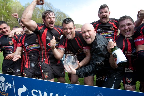 110513 - Wattstown v Pontycymmer, SWALEC League 4 South East - Wattstown RFC captain Nathan Bruford is presented with the SWALEC League 4 South East trophy by WRU board member Humphrey Evans, with coaches Dano Roberts, left, Wayne Davies and Christopher Davies, right