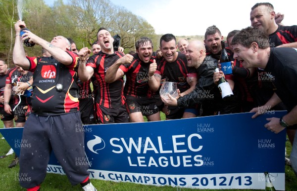 110513 - Wattstown v Pontycymmer, SWALEC League 4 South East - Wattstown RFC captain Nathan Bruford is presented with the SWALEC League 4 South East trophy by WRU board member Humphrey Evans, with coaches Dano Roberts, left, Wayne Davies and Christopher Davies, right