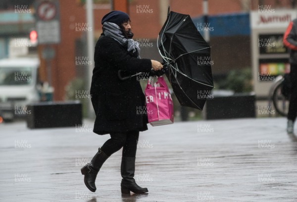 080216 - Storm Imogen, South Wales - Shoppers in the centre of Cardiff battle with the wind and rain as storm Imogen hits South Wales