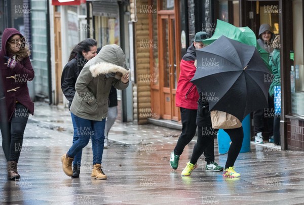 080216 - Storm Imogen, South Wales - Shoppers in the centre of Cardiff battle with the wind and rain as storm Imogen hits South Wales