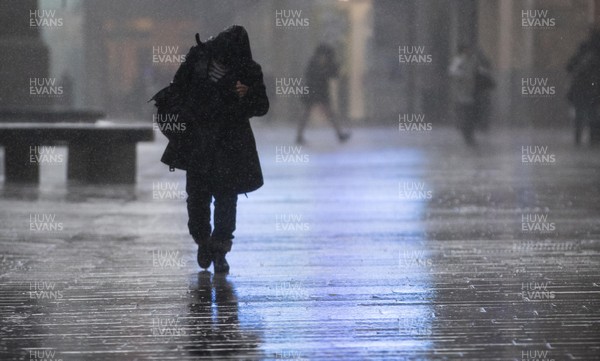 080216 - Storm Imogen, South Wales - Shoppers in the centre of Cardiff battle with the wind and rain as storm Imogen hits South Wales