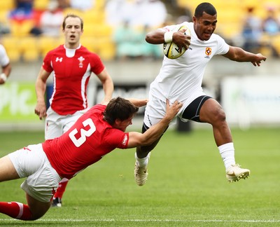 03.02.12 - Hertz Wellington Sevens - Tonga's Vaea Poteki jumps to evade Wales' Alex Walker.  