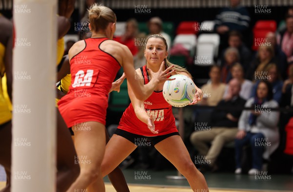 100124 - Welsh Feathers v Uganda, International Netball Series - Bethan Dyke of Welsh Feathers looks to pass to Phillipa Yarranton of Welsh Feathers
