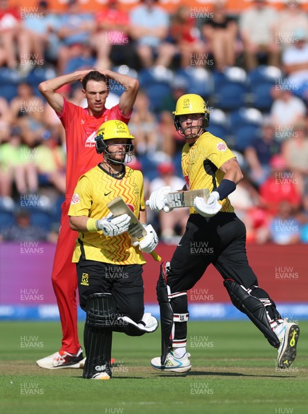 290726 - Welsh Fire Men v Trent Rockets Men, The Hundred - Finn Allen of Trent Rockets and Ben Duckett of Trent Rockets add the runs as Marco Jansen of Welsh Fire looks on