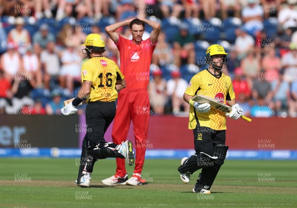 290726 - Welsh Fire Men v Trent Rockets Men, The Hundred - Finn Allen of Trent Rockets and Ben Duckett of Trent Rockets add the runs as Marco Jansen of Welsh Fire looks on