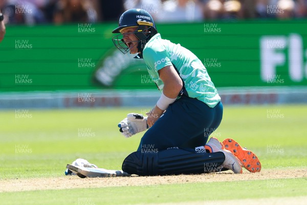 070822 - Welsh Fire v Oval Invincibles, The Hundred - Sam Billings of Oval Invincibles reacts after being struck by the ball