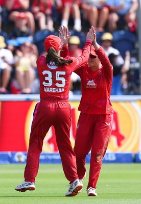 120826 - Welsh Fire Women v London Spirit Women, The Hundred - Abi Norgrove of Welsh Fire celebrates with Georgia Wareham of Welsh Fire after she catches Charlie Dean of London Spirit