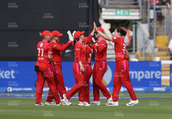 250726 - Welsh Fire Women v MI London Women - The Hundred - Georgia Voll and Em Arlott celebrates with team mates after taking the wicket of Melie Kerr of MI London