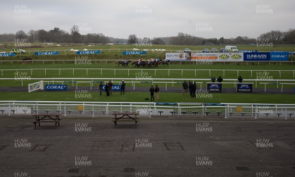 090121 - 2020 Coral Welsh Grand National Meeting - The field in the third race, The Coral Fail To Finish Free Bets Handicap Hurdle Race make their way around the course 