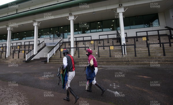 090121 - 2020 Coral Welsh Grand National Meeting - Jockeys make their way back to the Jockey's Rooms through empty stands at Chepstow Racecourse after of one of the races