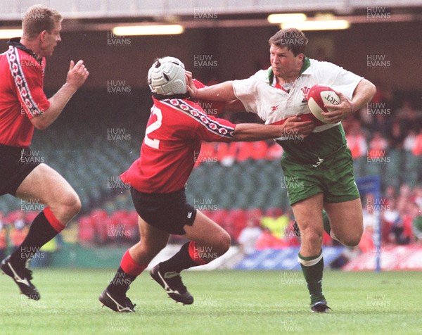 21.08.99 - Wales v Canada Scott Gibbs hands off Canada's Scott Bryan. 