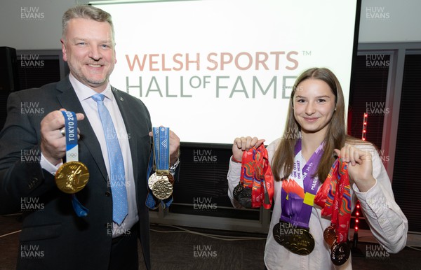 140923 - Welsh Sports Hall of Fame Dinner, Cardiff City Stadium - Simon Richards, father of champion swimmer Matt Richards, and swimmer Theodora Taylor with a selection of their medals