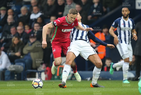070418 - West Bromwich Albion v Swansea City, Premier League - Andy King of Swansea City is brought down by Jake Livermore of West Bromwich Albion