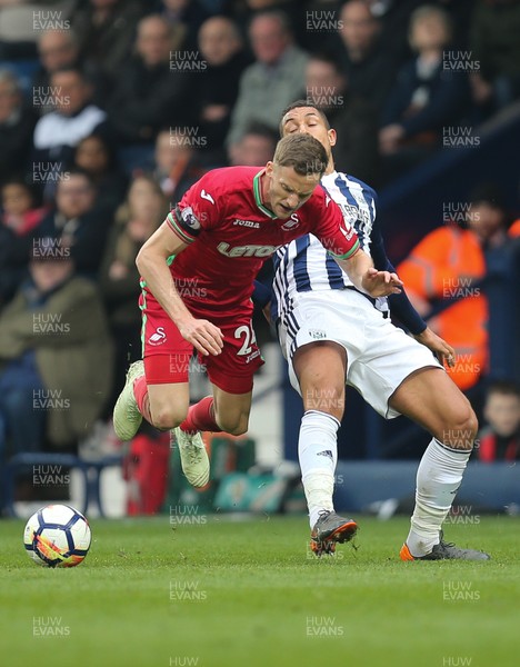 070418 - West Bromwich Albion v Swansea City, Premier League - Andy King of Swansea City is brought down by Jake Livermore of West Bromwich Albion