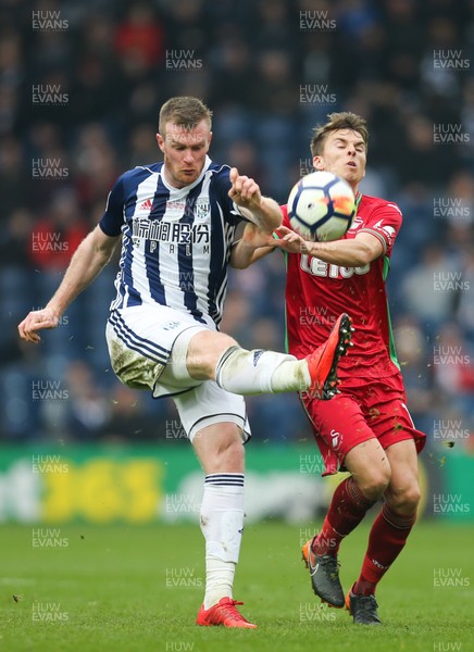 070418 - West Bromwich Albion v Swansea City, Premier League - Chris Brunt of West Bromwich Albion clears the ball as Tom Carroll of Swansea City closes in
