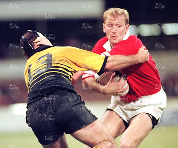 290596 - Western Australia v Wales -  Gareth Thomas of Wales shrugs off the tackle of Mark Skiffington