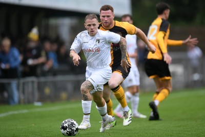 150725 - Weston-Super-Mare v Newport County - Preseason Friendly - James Waite of Weston Super-Mare is challenged by Lee Jenkins of Newport County