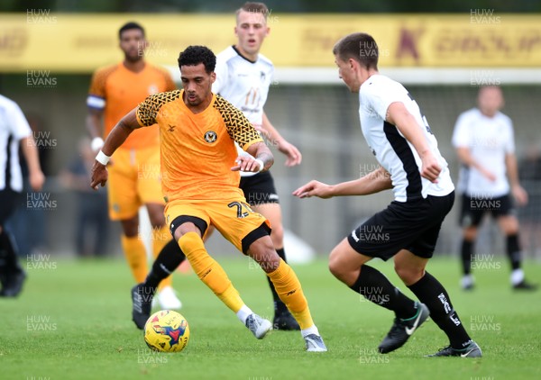 220719 - Weston Super Mare v Newport County - Preseason Friendly - Corey Whitely of Newport County is tackled by Aaron Parsons of Weston Super Mare