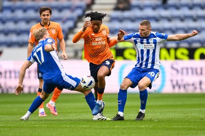 270925 - Wigan Athletic v Cardiff City - Sky Bet League 1 -  Gabriel Osho of Cardiff Cityis tackled by Matt Smith of Wigan Athletic