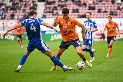 270925 - Wigan Athletic v Cardiff City - Sky Bet League 1 -  Rubin Colwill of Cardiff City is tackled by Will Aimson of Wigan Athletic