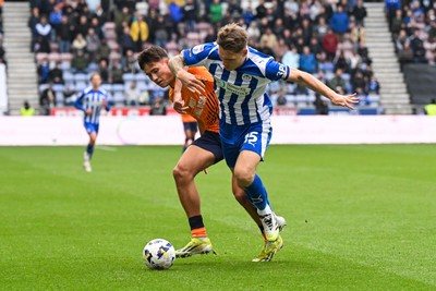 270925 - Wigan Athletic v Cardiff City - Sky Bet League 1 -  Rubin Colwill of Cardiff City and Jason Kerr of Wigan Athletic battle for the ball