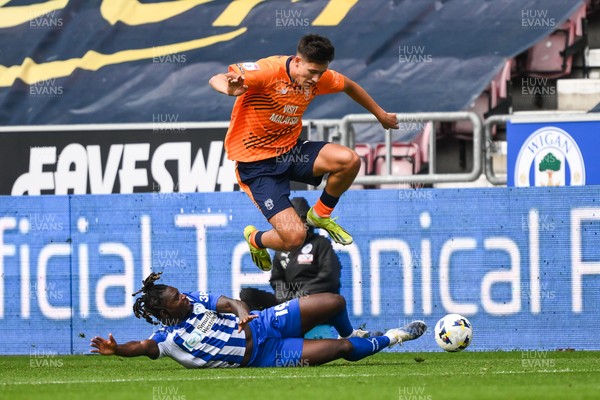 270925 - Wigan Athletic v Cardiff City - Sky Bet League 1 -  Rubin Colwill of Cardiff City is tackled by Baba Adeeko of Wigan Athletic
