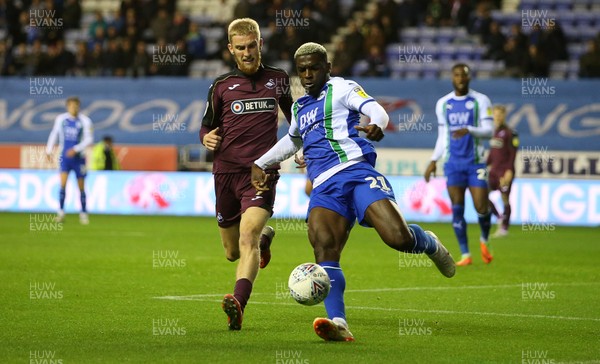 021018 - Wigan Athletic v Swansea City - SkyBet Championship - Cedric Kipre of Wigan is challenged by Oli McBurnie of Swansea City