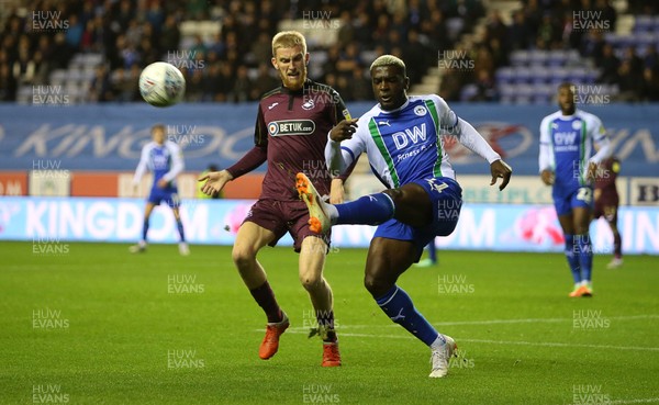021018 - Wigan Athletic v Swansea City - SkyBet Championship - Cedric Kipre of Wigan is challenged by Oli McBurnie of Swansea City