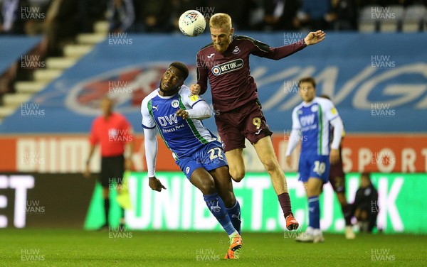 021018 - Wigan Athletic v Swansea City - SkyBet Championship - Oli McBurnie of Swansea City is challenged by Cheyenne Dunkley of Wigan