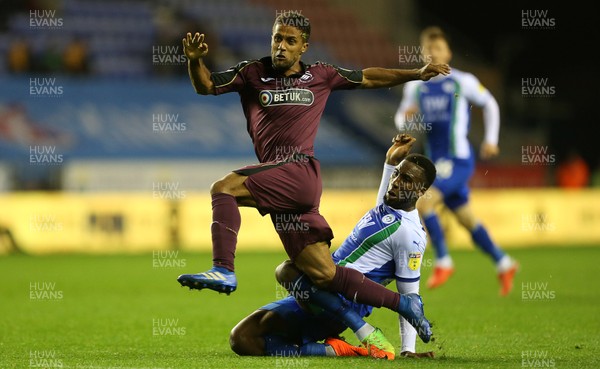 021018 - Wigan Athletic v Swansea City - SkyBet Championship - Wayne Routledge of Swansea City is tackled by Cheyenne Dunkley of Wigan