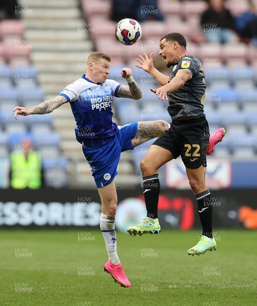 100423 - Wigan Athletic v Swansea City - Sky Bet Championship - Joel Latibeaudiere of Swansea and James McClean of Wigan Athletic