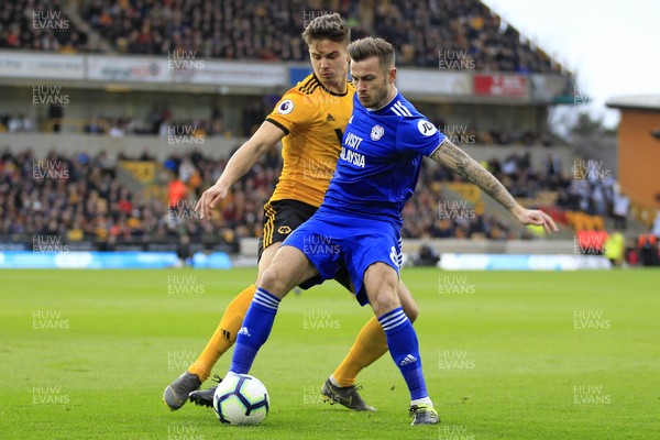 020319 - Wolverhampton Wanderers v Cardiff City, Premier League - Joe Ralls of Cardiff City (right) shields the ball from Leander Dendoncker of Wolverhampton Wanderers
