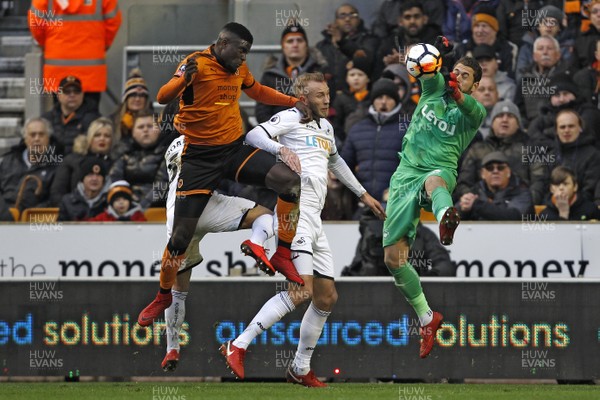 060118 - Wolverhampton Wanderers v Swansea City, FA Cup Third Round - Kristoffer Nordfeldt of Swansea City (right) saves from Alfred N'Diaye of Wolverhampton Wanderers (left)