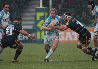 04.02.12 Worcester v Ospreys - LV=Cup -.Ospreys' Tom Issacs takes on Worcester's Sam Betty(R) and Tevita Taumoepeau.