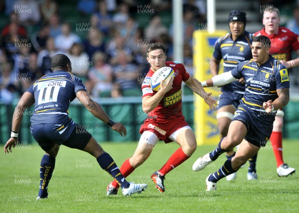 180812 - Worcester v Scarlets - Pre Season Friendly -  Scarlets' Dan Newton , centre, looks to avoid Worcester's Josh Drauniniu, left   