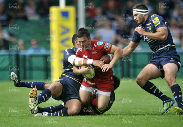 180812 - Worcester v Scarlets - Pre Season Friendly -  Scarlets' Jordan Williams, centre, is hauled down  