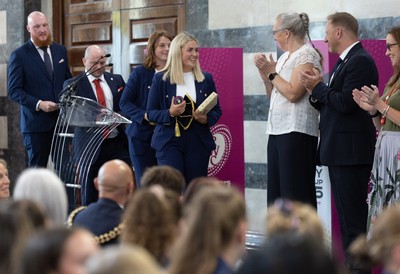 170825 - Women’s Rugby World Cup Welcome Ceremony - Wales co-captains Alex Callendar and Kate Williams and Sean Lynn, Wales Women head coach receive their caps and participation medal at the Women’s Rugby World Cup welcome ceremony at Manchester Town Hall