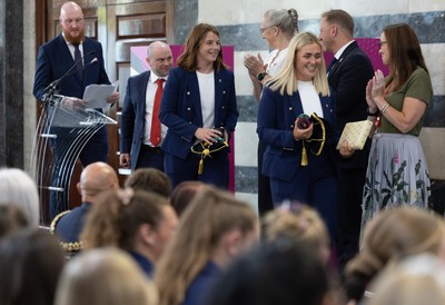 170825 - Women’s Rugby World Cup Welcome Ceremony - Wales co-captains Alex Callendar and Kate Williams and Sean Lynn, Wales Women head coach receive their caps and participation medal at the Women’s Rugby World Cup welcome ceremony at Manchester Town Hall