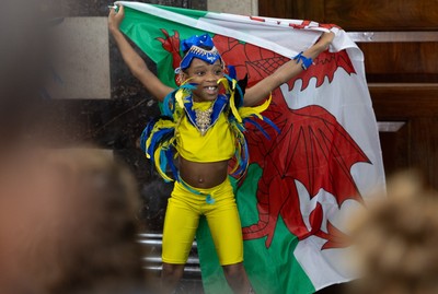 170825 - Women’s Rugby World Cup Welcome Ceremony - A young dancer with the Wales flag during the Women’s Rugby World Cup welcome ceremony at Manchester Town Hall
