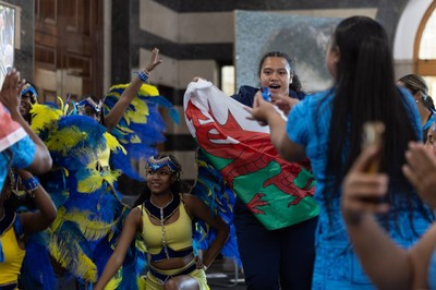 170825 - Women’s Rugby World Cup Welcome Ceremony - Wales’ Sisilia Tuipulotu take the Wales flag and joins in with the welcome dance troop at the Women’s Rugby World Cup welcome ceremony at Manchester Town Hall